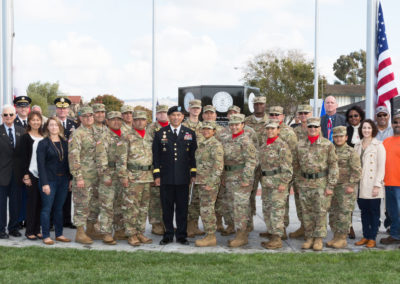 Group photo of Richard Valle, Manny Fernandez, Ret. Brigadier General Chet Ward, Major General Garrett Yee, and U.S. Army service members, Monument dedication Saturday, November 11, 2017