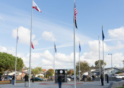 Flag poles and a monument in center, Monument dedication Saturday, November 11, 2017